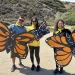 Volunteers holding Monarch butterfly cutouts 