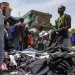 A head porter carries a bale of Second-hand clothes at Kantamanto market, one of the world's largest second-hand clothes markets in Accra, Ghana, Thursday, Oct. 31, 2024. (AP Photo/Misper Apawu) 
