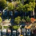 An aerial view of a lush community flushed with autumnal colors.