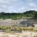 The canyon walls surround the Kings Mountain mine with trees and shrubs on the rim.