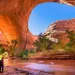A hiker at Jacob Hamblin Arch in Coyote Gulch, Grand Staircase-Escalante National Monument, Utah, United States
