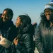 Three students huddled together atop Stone Mountain