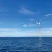 Wind turbines poke out of blue ocean water at the South Fork Wind farm.