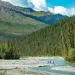 Three people on a river in the backcountry of Alaska