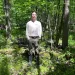Bird Logan, a citizen of the Tonawanda Seneca Nation, standing in the middle of the Big Woods. 