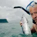 Andrew holds two tuna fish in Samoa. | Courtesy of the Travel Channel