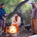 Veterans Kajetan Bauer, Brandon Lay, and Armando Medina sit around a campfire near Cedar Mesa, Utah.