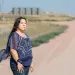 Kandi Mossett stands near the center of North Dakota’s oil fields.