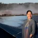 Jana Ganion, sustainability director for Blue Lake Rancheria, stands in front of a solar panel array.
