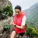 A woman runs along a cliff with a Suunto watch on her left wrist