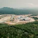 A rail construction site sits in the middle of lush, green peatlands.