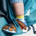 Turquoise Deuter Kid Comfort Active SL backpack with a toddler leg in a stirrup