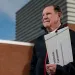 John Bohney holds a folder labeled Medicaid Expansion