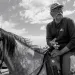 Willie Grayeyes, wearing a ballcap and riding a horse