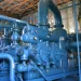 A whole lot of big blue bendy pipes in an industrial space. 