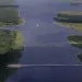 Giant concrete barrier, kind of like an enormous Q-tip, stretching across blue water and marshland