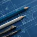Indigo-colored engineering drawning with two nicely sharpened pencils and a compass