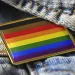 Rainbow flag pin on a denim backdrop