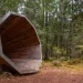 A large wooden megaphone sits in a forest in Pähni, Estonia.
