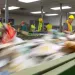 Workers in Portland Maine sort paper at Ecomaine recycling plant to remove contaminated recycling from the waste stream.