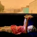 A young girl lies inside on a bench by a window holding an iPad over her head. Above her, out the window, the sky is orange from wildfire smoke.
