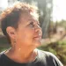 Rosanna Esparza wears a black shirt and looks off to the side as the sun shines on her.