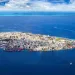 Crowded metropolis jammed onto an island in the middle of the blue ocean