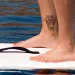 Knees bent, feet shoulder-width apart, Margaux Vair coasts on a standup paddleboard. Vair's tattoo commemorates her fallen comrades—Sergeants Michael Peek, Ashly Lynn Moyer, and Brandon Parr—who died in Iraq on March 3, 2007.