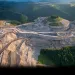 Mining firms must maintain a 100-foot protective zone around such burial grounds. The nearby Jarrell Cemetery, where Cook's great-grandfather is buried, is surrounded on all sides by a mining operation—a tree-studded atoll rising from a moonscape sea. | A