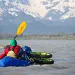 Ryan Krueger's wheels, rigged onto his packraft, are lapped by the Dangerous River