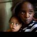 Marianna Hildreth, 7, holds her cousin Mariyah McGhee, 1, who has asthma, in their grandmother's kitchen in River Rouge, Michigan. | Ami Vitale/Panos Pictures