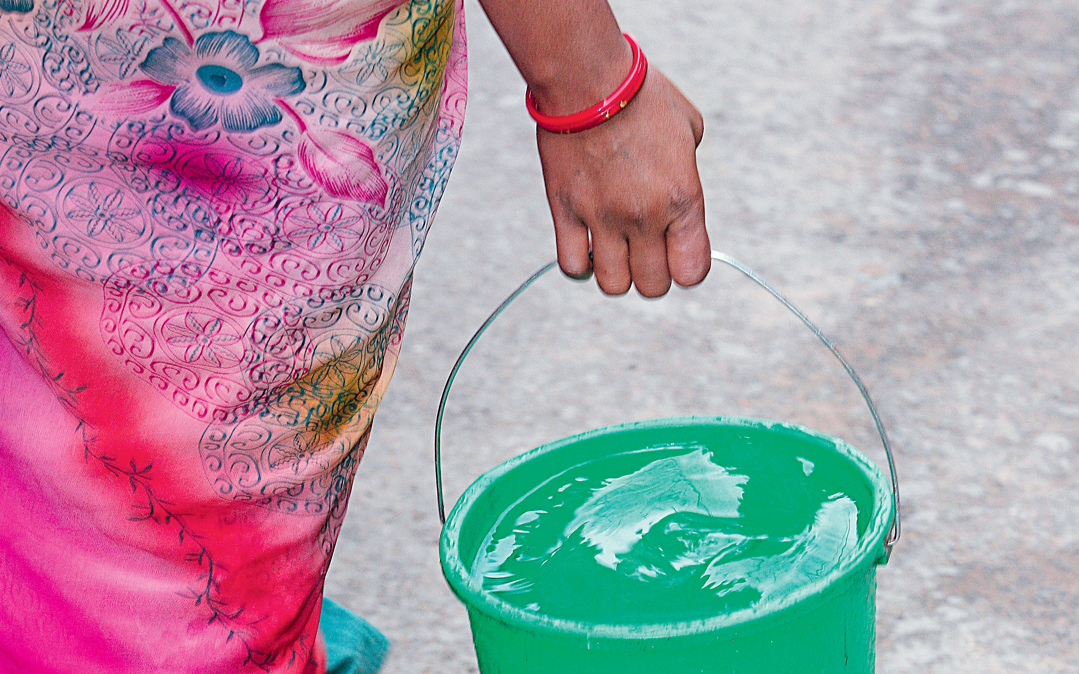 A woman carries water in Kathmandu, Nepal.