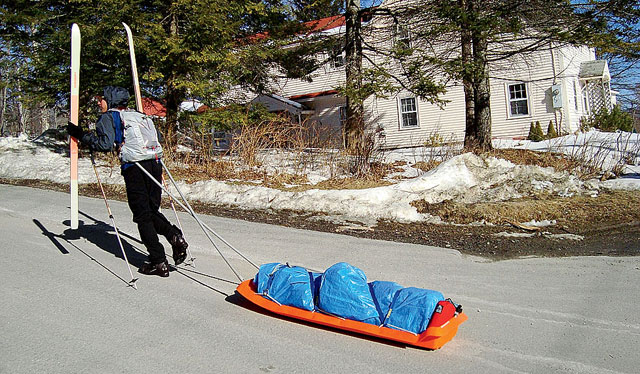 The author hauls gear on warm pavement.