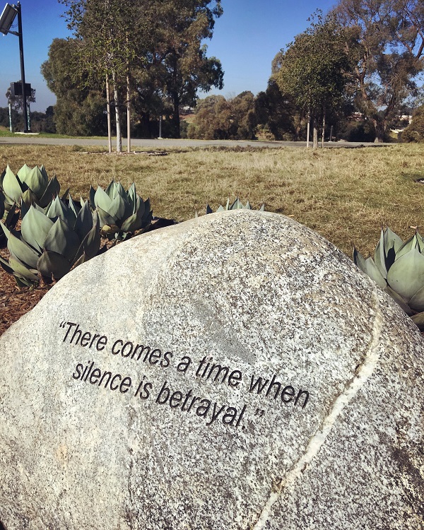 A stone inscribed with the words "There comes a time when silence is betrayal."
