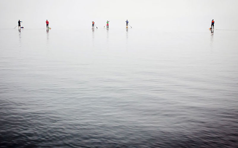 Gear lashed, paddles in hand, the group glides through the mist in the Great Bear Rainforest.