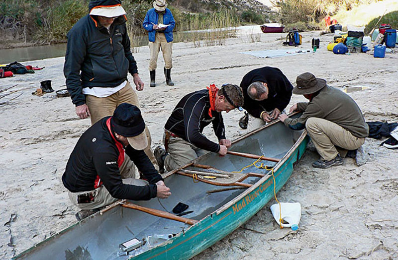 Repairing a canoe that collided with a boulder in Palmas Rapid, 40 miles into the 83-mile trip. No one was hurt, and the canoe was successfully relaunched.