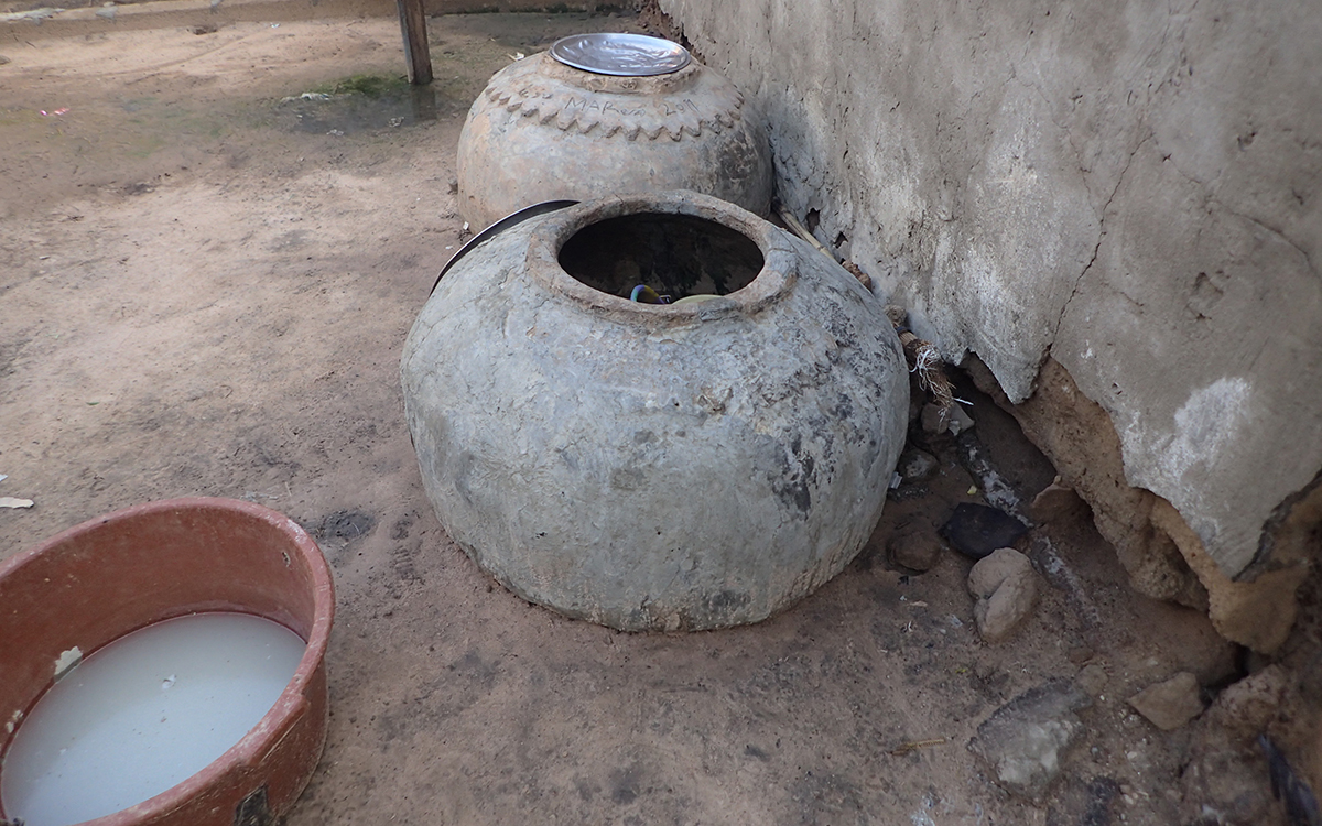 Image of some earthen jars and a washbasin as an example of where mosquitoes lay their eggs