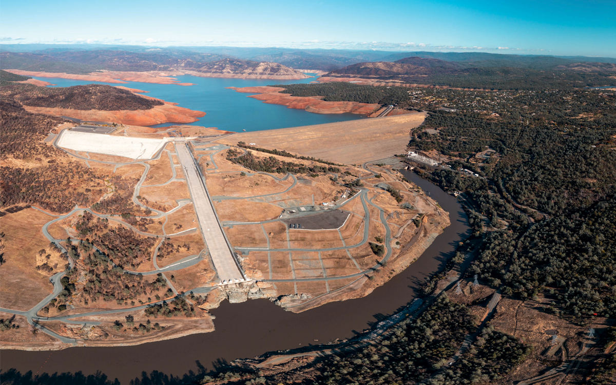 Aerial view of the Oroville Dam with blue skies above.