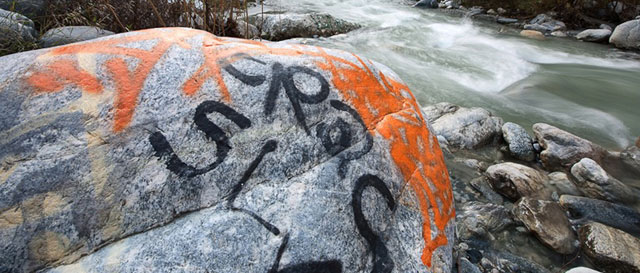 Graffiti mars the banks of the east fork of the San Gabriel River in Cattle Canyon.