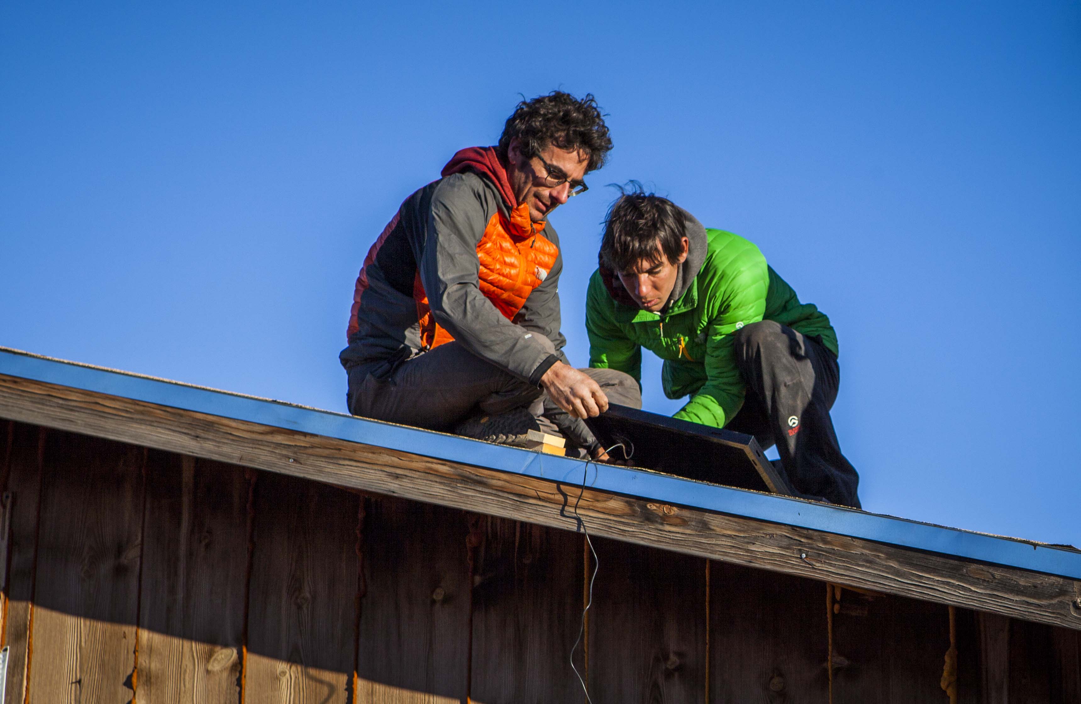 Cedar Wright and Alex Honnold install solar panels.