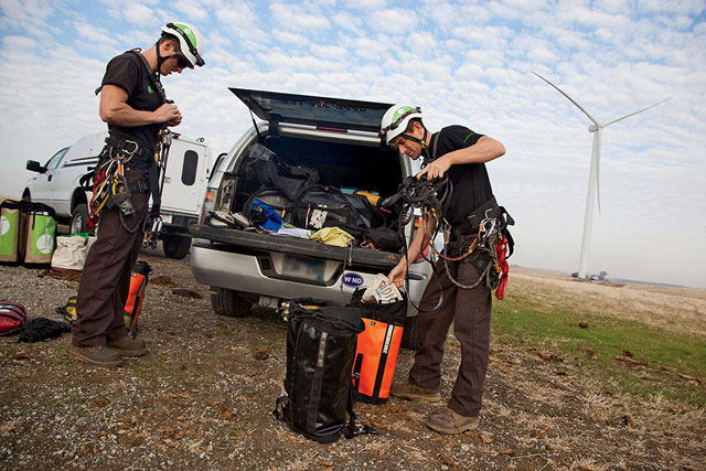 Working as a team, Gaunt (left) and Josh Crayton gear up before rappelling down a turbine.