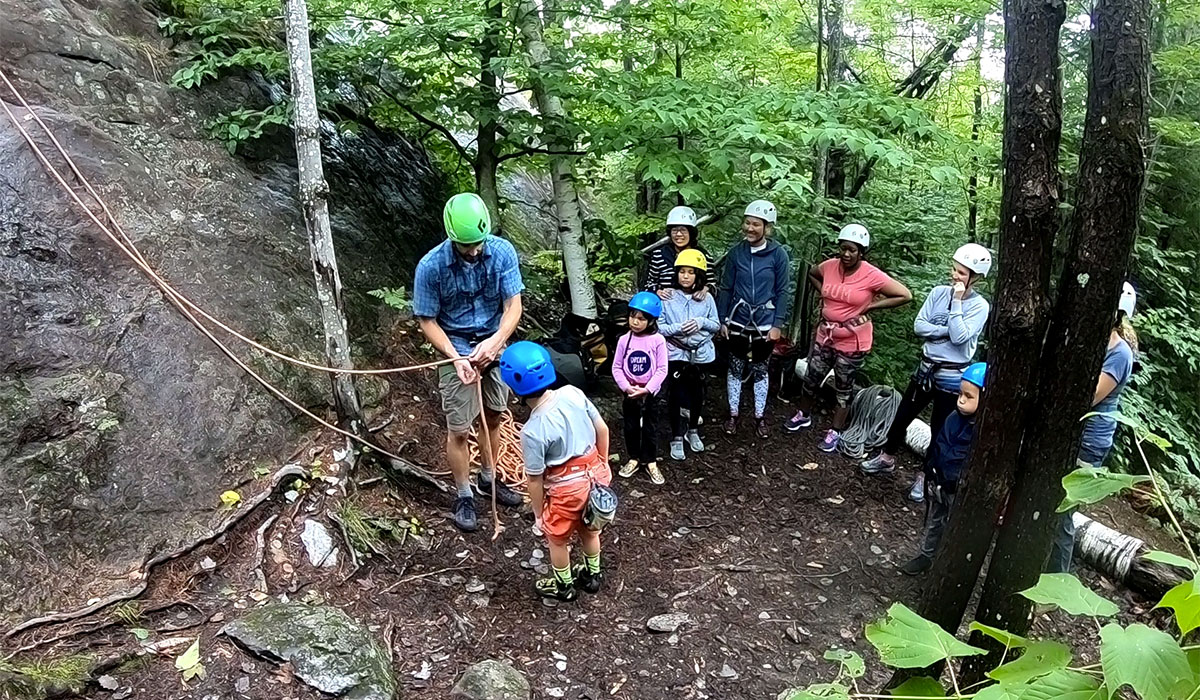 Families learning to rock climb.