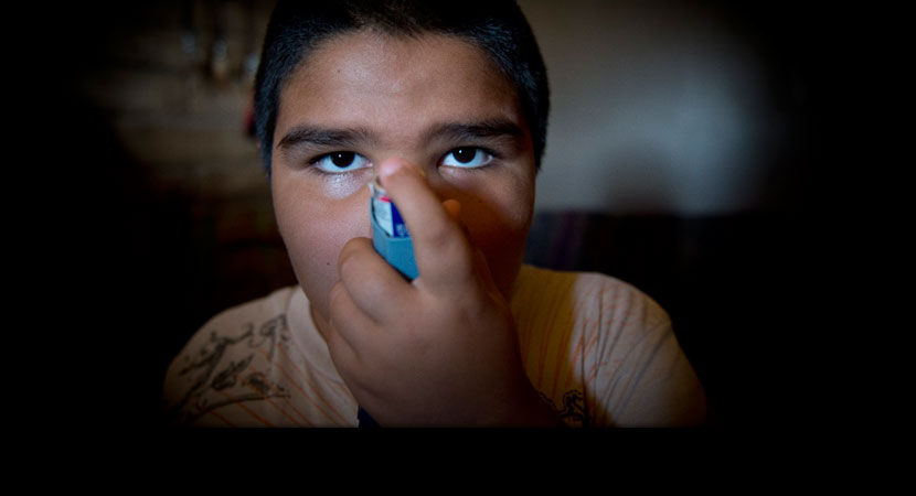 Gyiel Hernandez demonstrates his inhaler. "When he was a couple of months old, I had to take him back to the hospital because of asthma," said his mother, Surita.