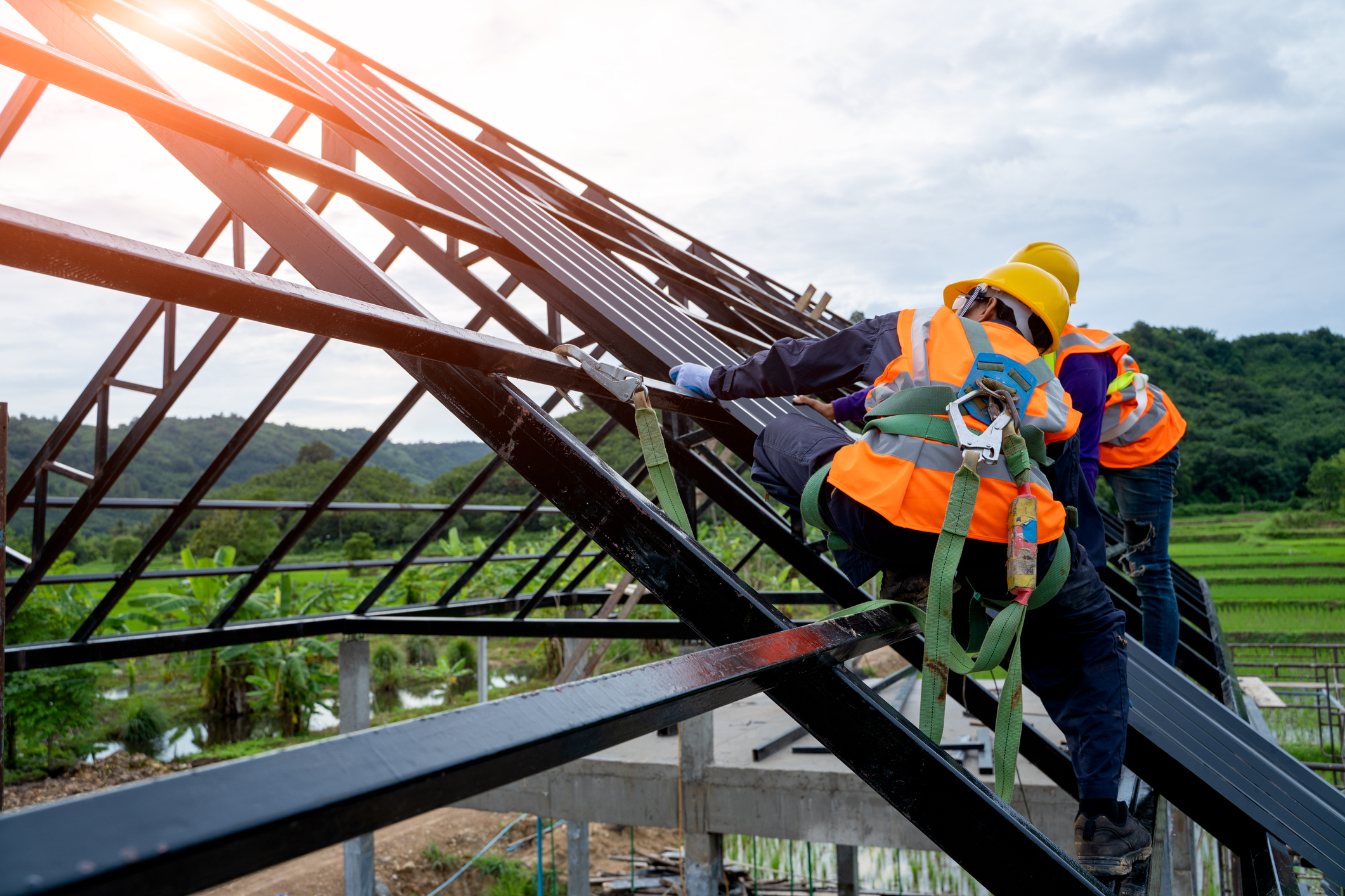 Two workers building a roof