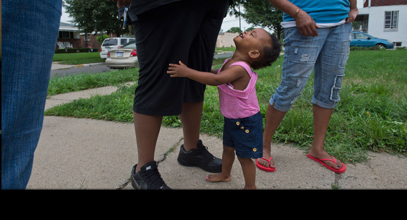 Siobhan Washington's granddaughter Mariyah McGhee, who has asthma, holds the leg of her mother, Jasmine McGhee.