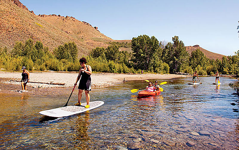 'We get to do standup paddleboarding? Yes! That's been on my bucket list!' said Rachel Cisneros, shown here circumnavigating a Sun Valley pond with fellow camp participants.