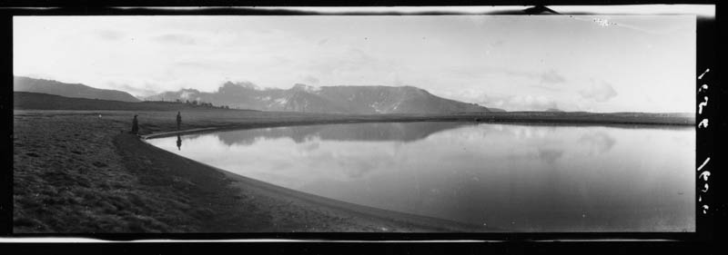 Two figures at unknown lake