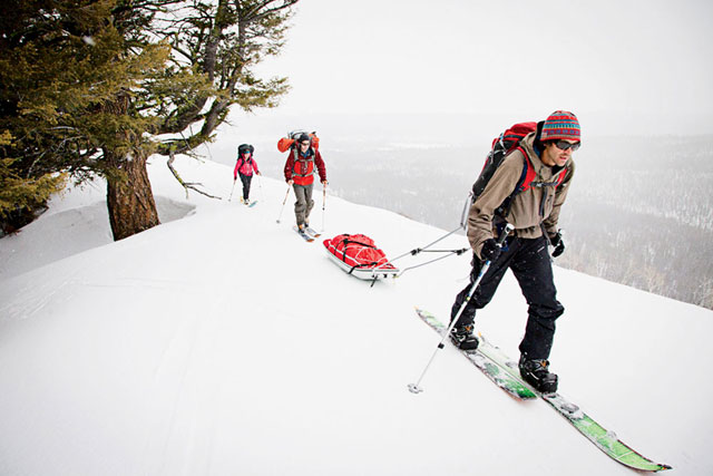 Clark Corey and two camp participants haul four days' worth of gear and food six miles to Sawtooth Mountain Guides' backcountry yurts.