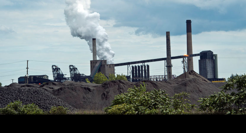 Just across the waterway from Morris's fishing spot is Zug Island, home to a steel mill and piles of coal. | Ami Vitale/Panos Pictures