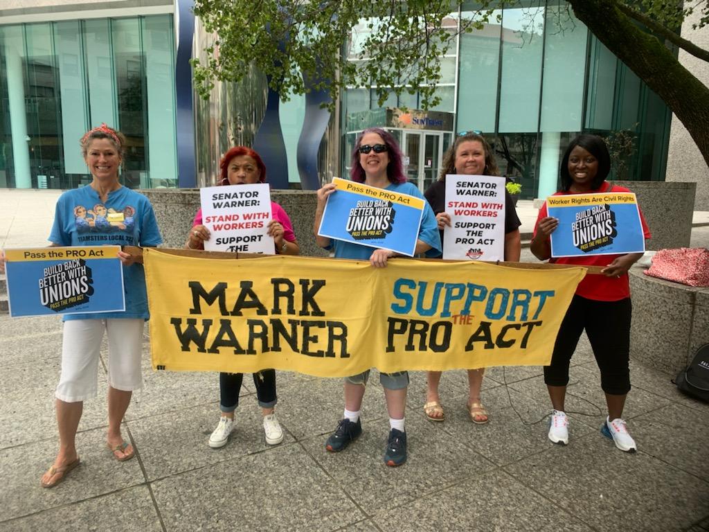 Rally-goers in Richmond, Virginia holding up climate action signs